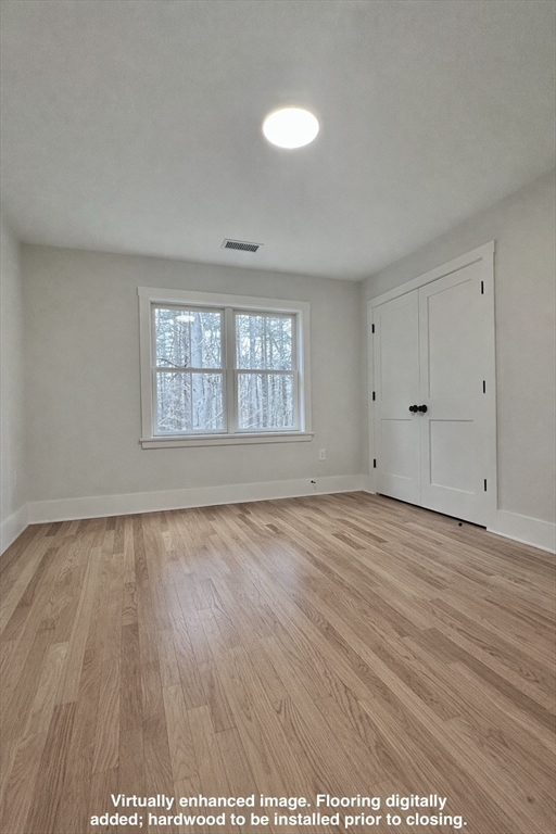 16 R Eldor Drive Walpole, MA 02071 - Photo 16 of 28 an empty room with wooden floor and windows
