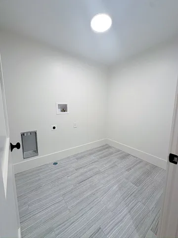 a view of a room with wooden floor