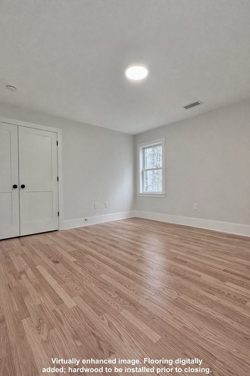 16 R Eldor Drive Walpole, MA 02071 - Photo 17 of 28 a view of an empty room with window and wooden floor