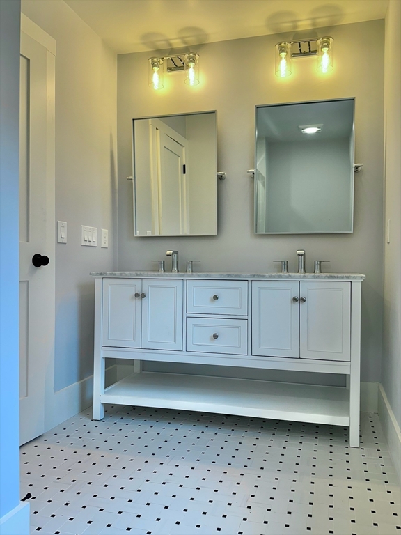 16 R Eldor Drive Walpole, MA 02071 - Photo 19 of 28 a bathroom with a sink a toilet and a mirror