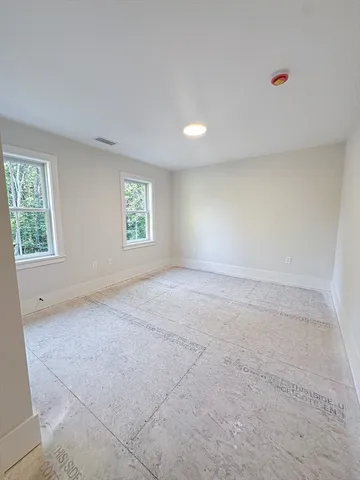 an empty room with windows and closet