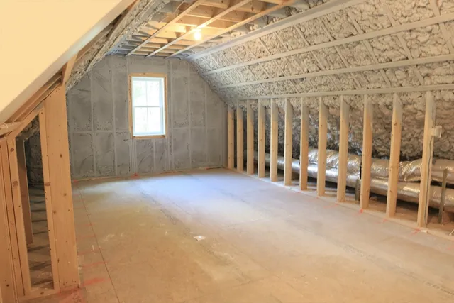 a view of an empty room with a refrigerator