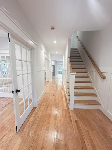 a view of a living room with wooden floor and staircase