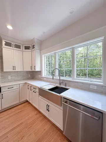 a kitchen that has a sink and a stove in it