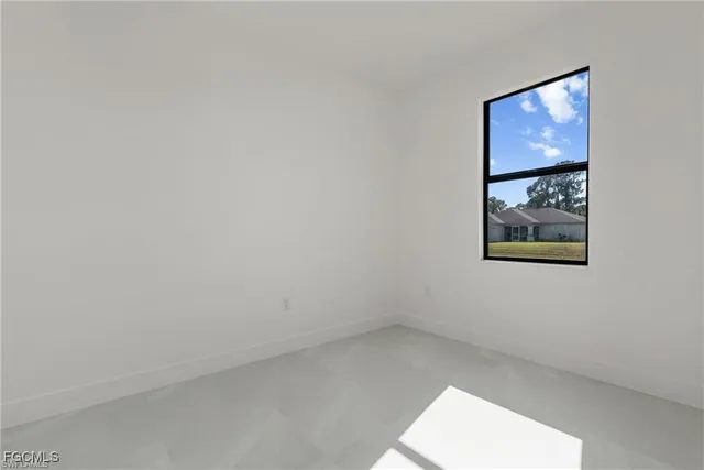 an empty room with a painting on the wall