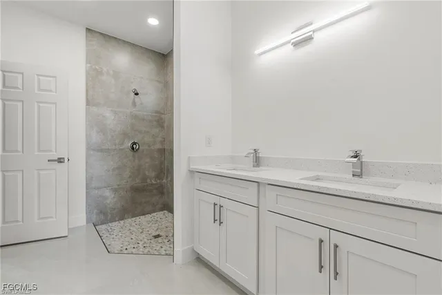 a bathroom with a double vanity sink and mirror