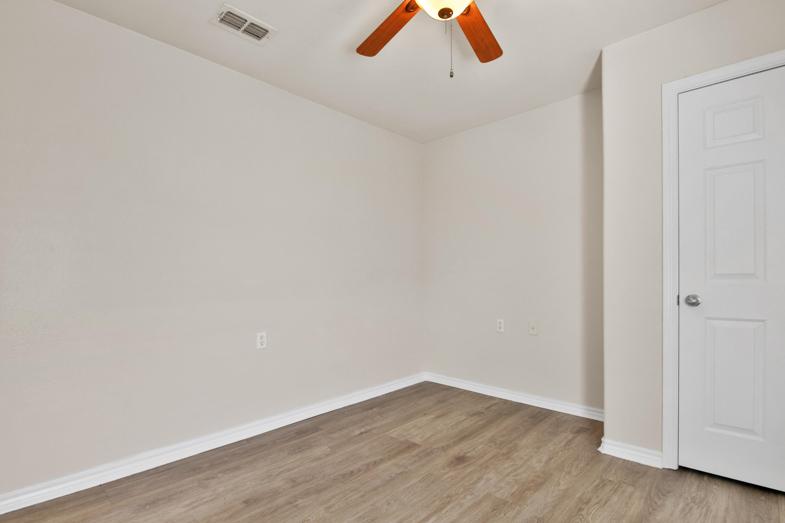 2117 99th Street Lubbock, TX 79423 - Photo 16 of 30 a view of an empty room with wooden floor