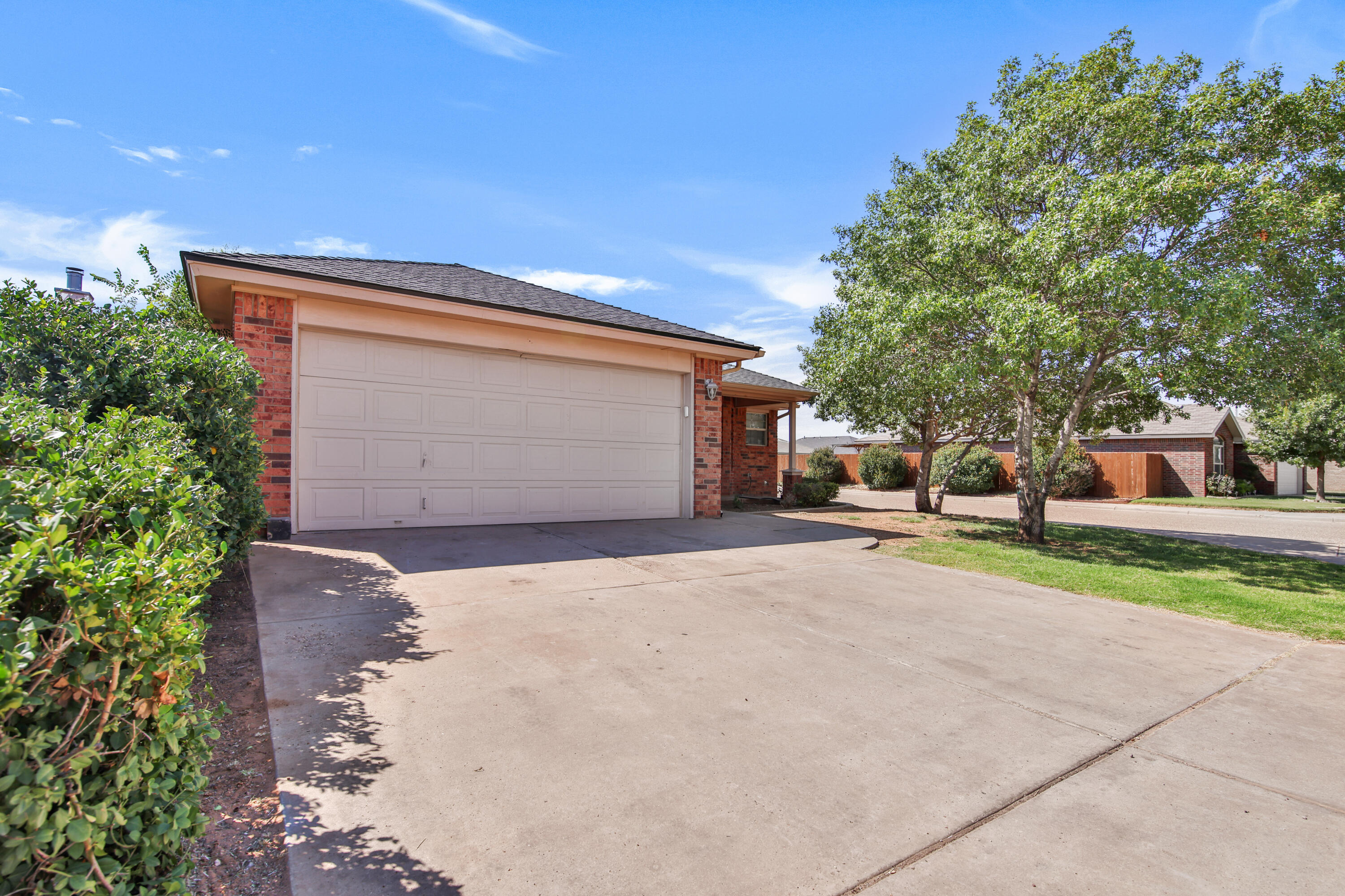 2117 99th Street Lubbock, TX 79423 - Photo 2 of 30 a front view of a house with a yard and garage