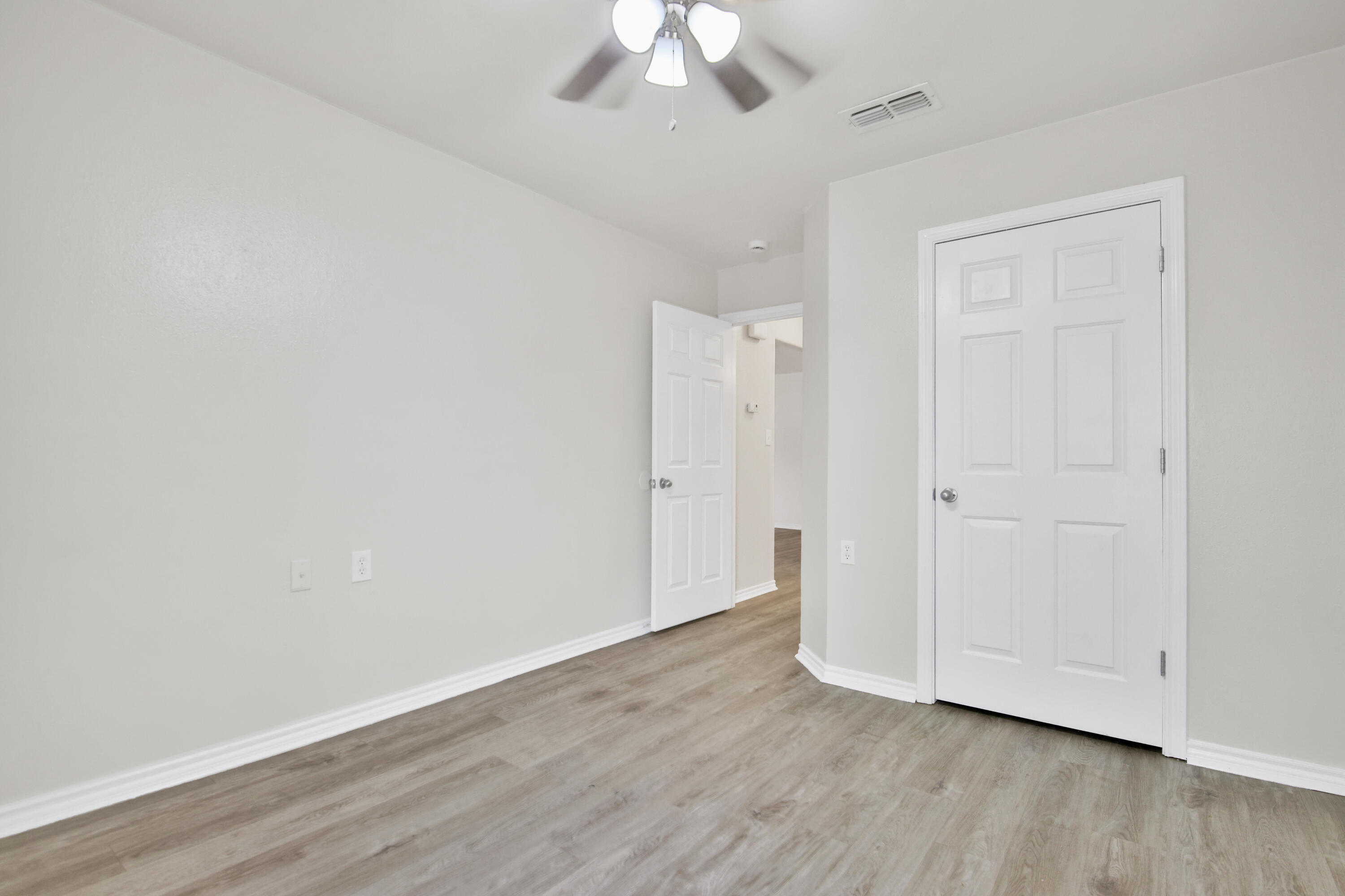 2117 99th Street Lubbock, TX 79423 - Photo 21 of 30 a view of an empty room with wooden floor