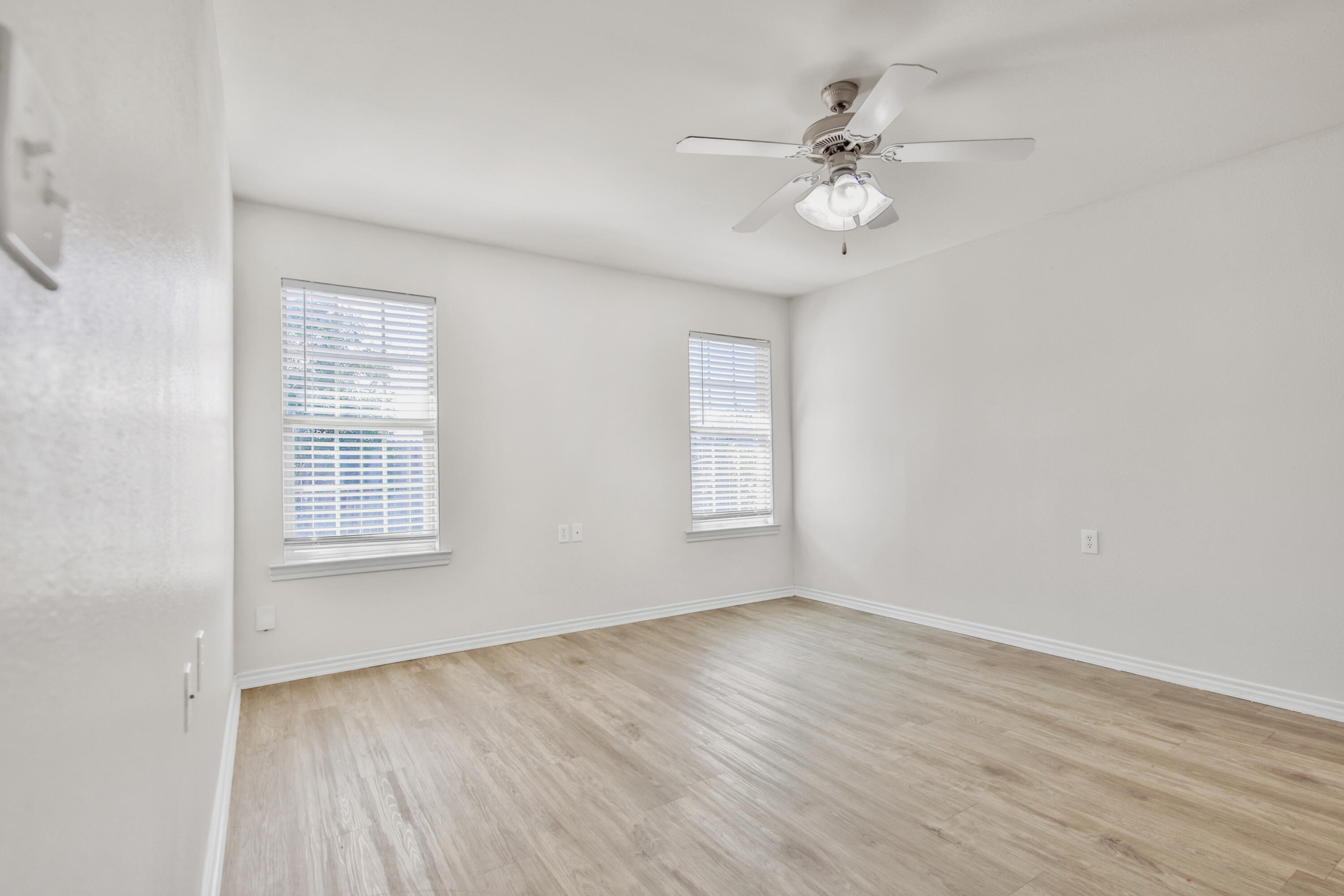 2117 99th Street Lubbock, TX 79423 - Photo 22 of 30 wooden floor in an empty room with a window