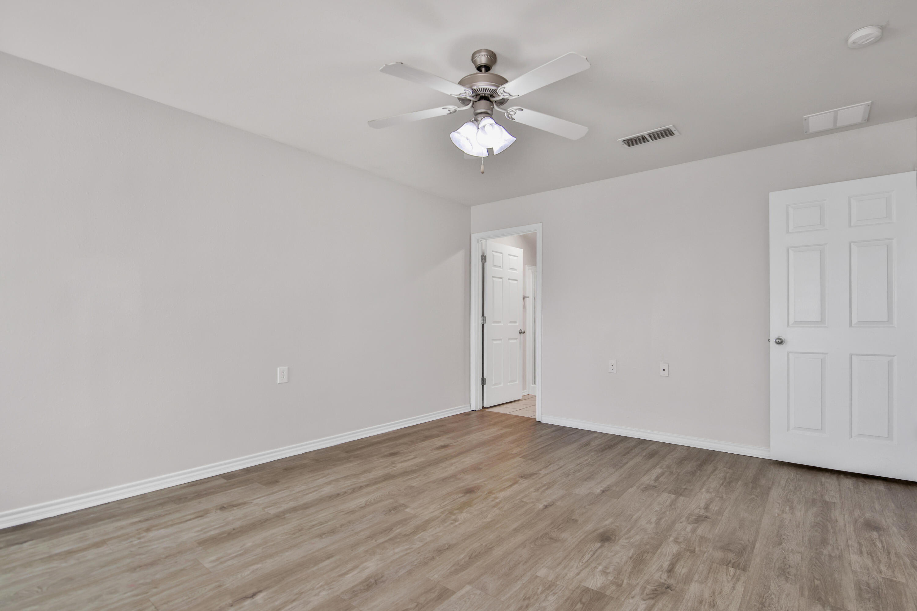 2117 99th Street Lubbock, TX 79423 - Photo 23 of 30 a view of an empty room with wooden floor