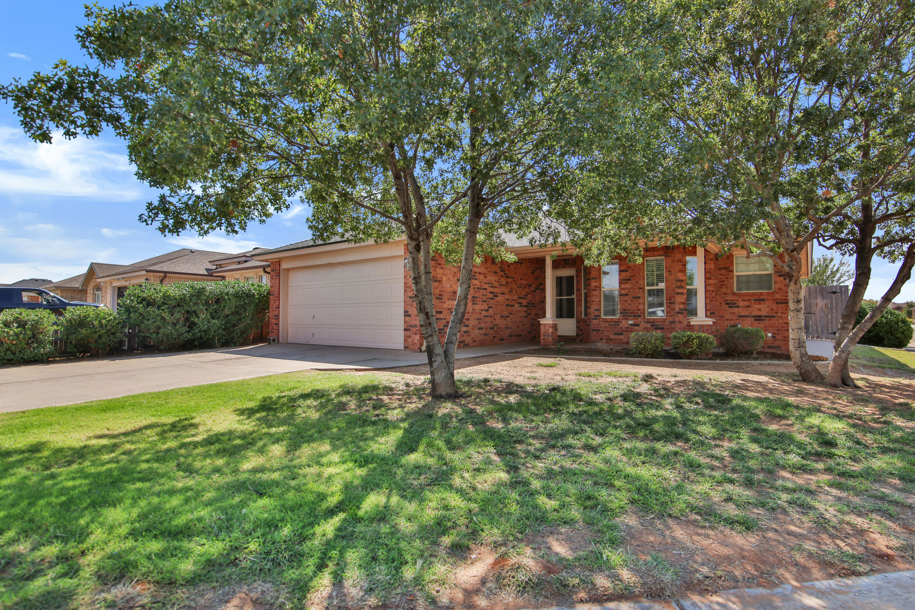 2117 99th Street Lubbock, TX 79423 - Photo 3 of 30 a backyard of a house with lots of green space
