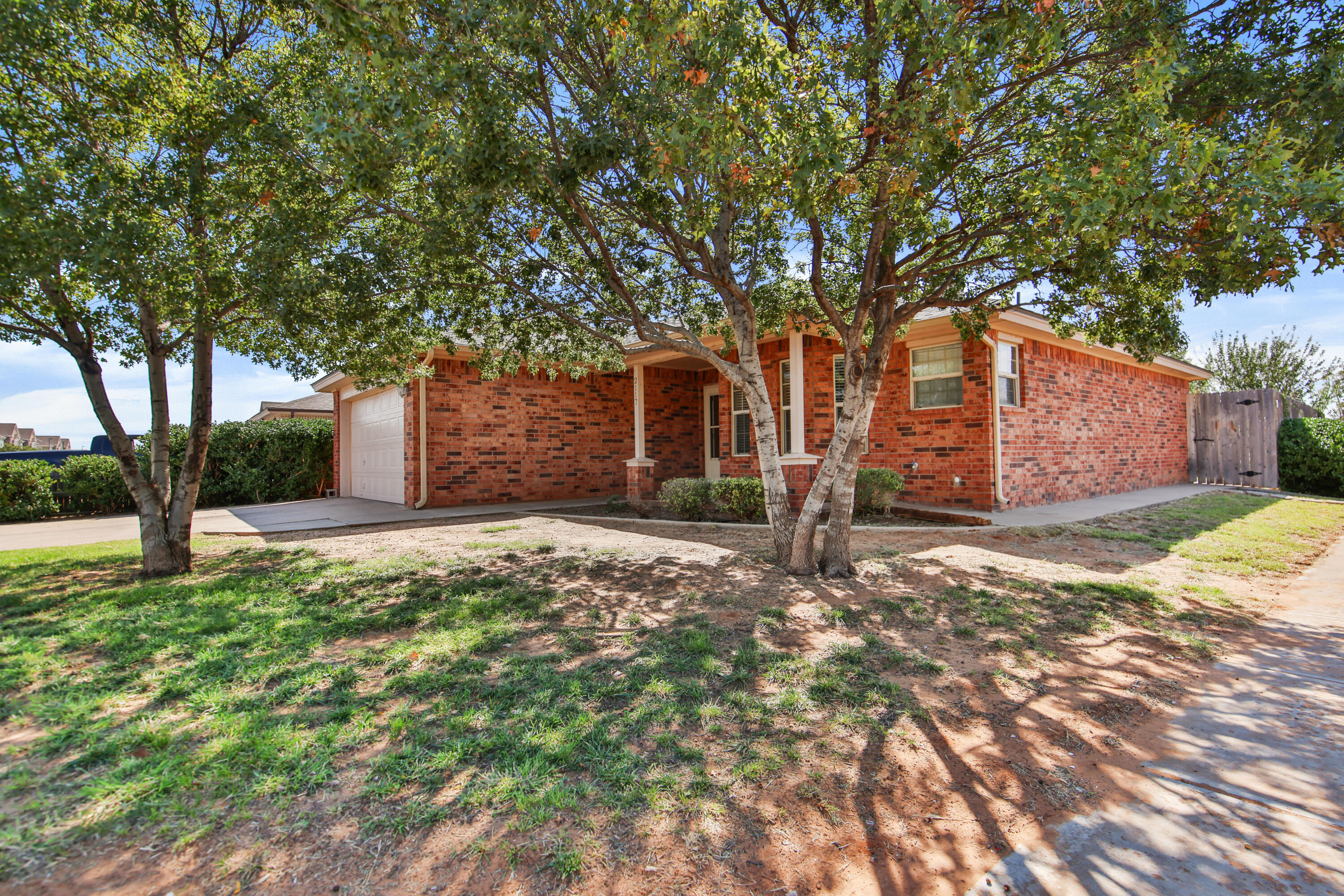 2117 99th Street Lubbock, TX 79423 - Photo 4 of 30 a front view of a house with garden