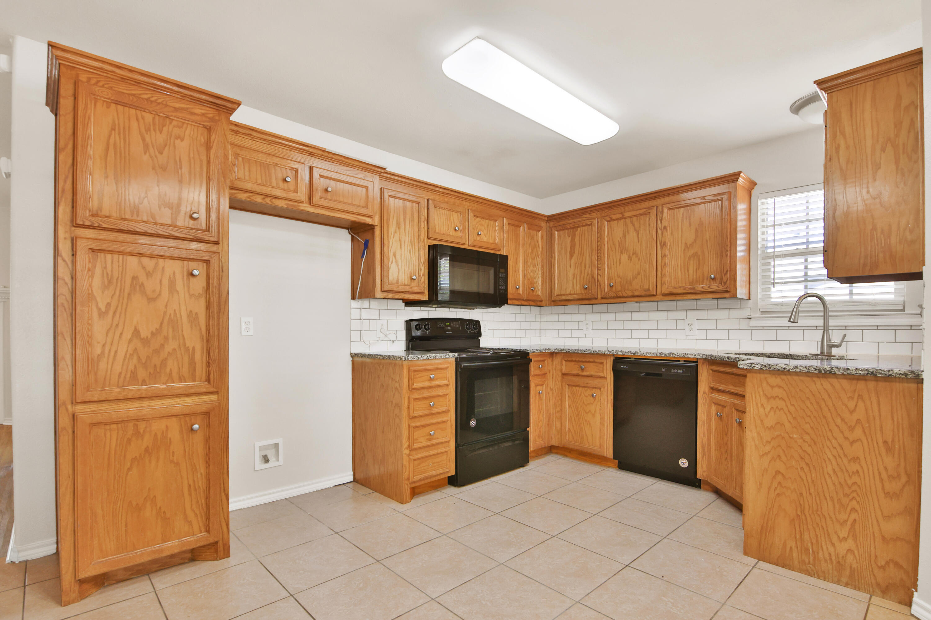 2117 99th Street Lubbock, TX 79423 - Photo 8 of 30 a kitchen with stainless steel appliances granite countertop a refrigerator and microwave