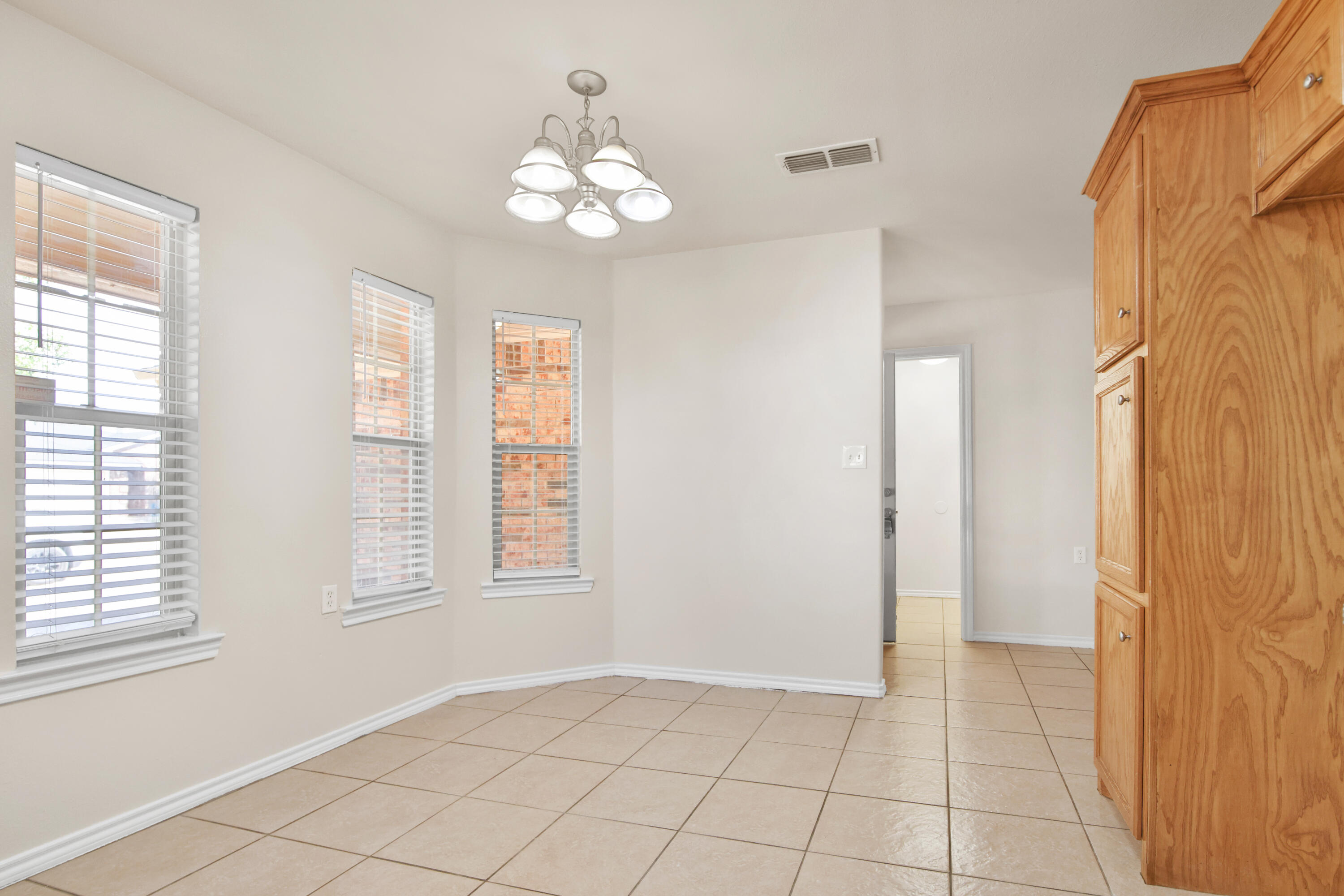 2117 99th Street Lubbock, TX 79423 - Photo 9 of 30 a view of an empty room with a window