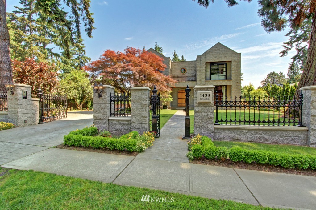 a front view of a house with a yard and a garden