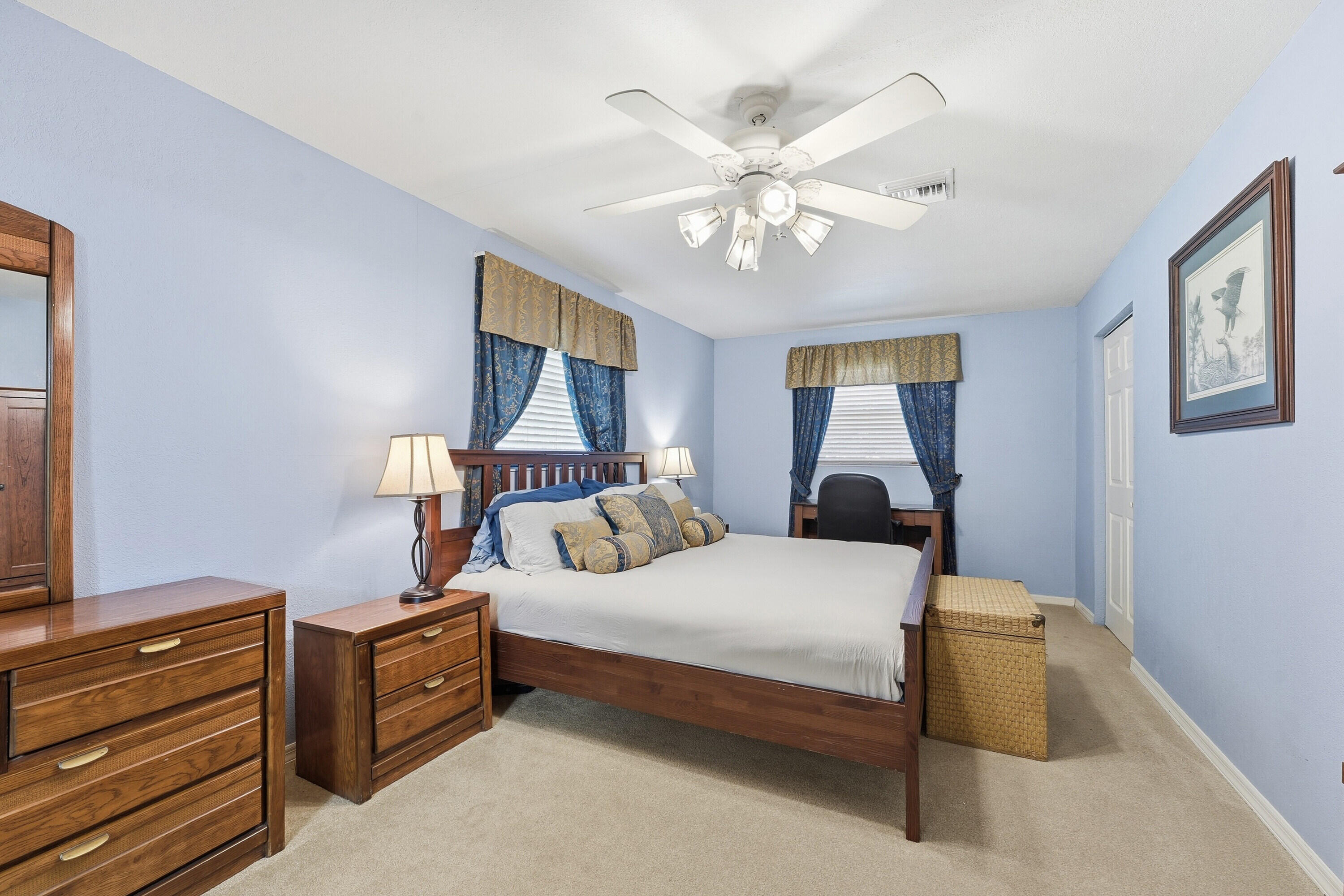 200 Windy Point Road Lake Placid, FL 33852 - Photo 14 of 74 a bedroom with a bed and a chandelier