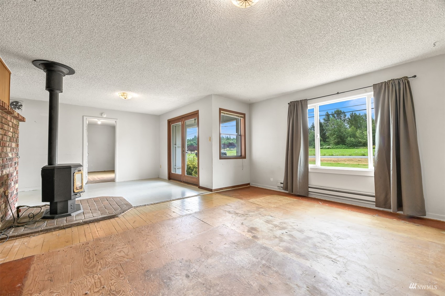 718 East Laurel Road Bellingham, WA 98226 - Photo 24 of 40 a view of a livingroom with an empty space and a fireplace
