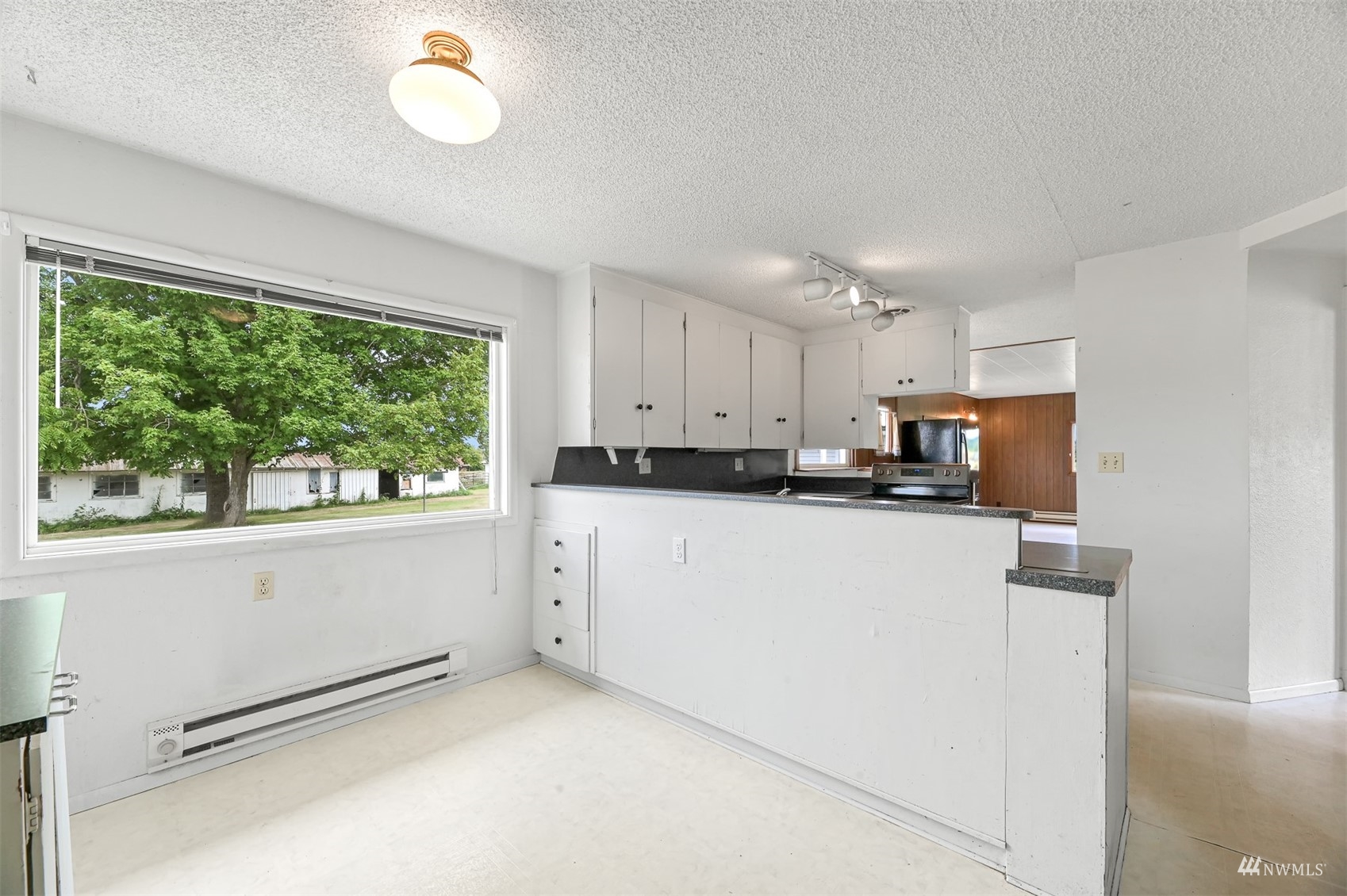 718 East Laurel Road Bellingham, WA 98226 - Photo 27 of 40 a kitchen with granite countertop white cabinets and a window