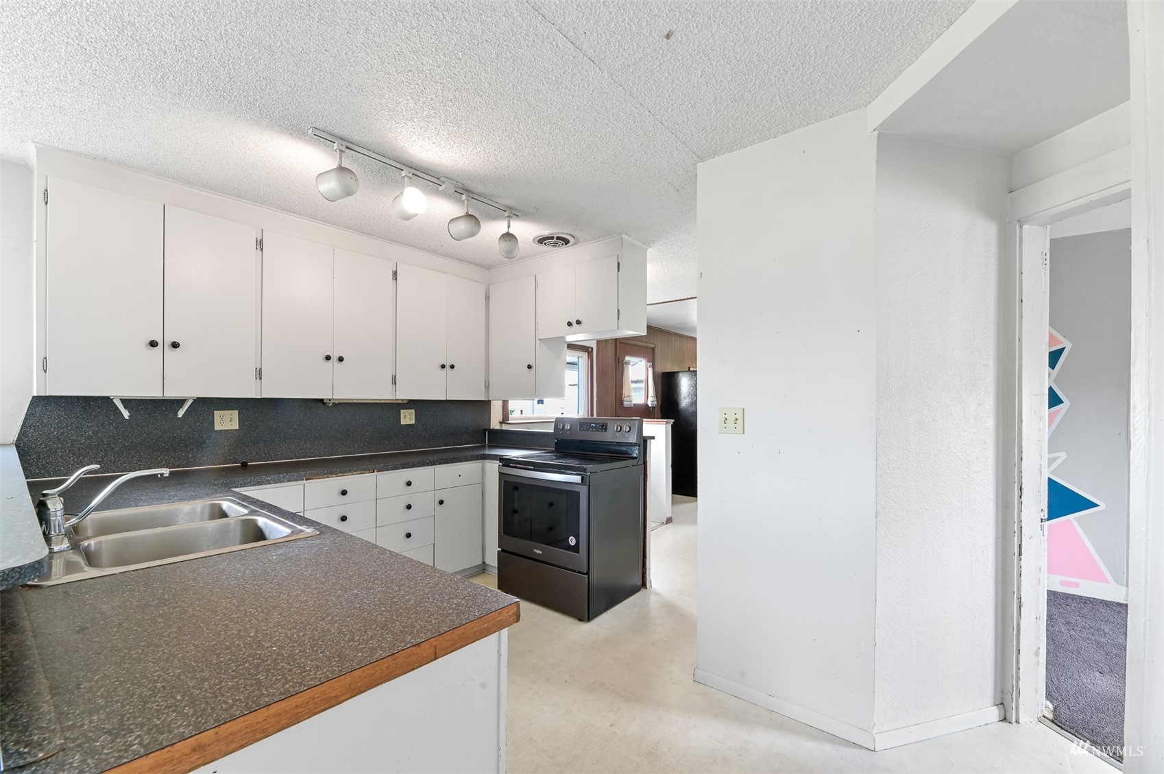 718 East Laurel Road Bellingham, WA 98226 - Photo 29 of 40 a kitchen with a sink stove and cabinets