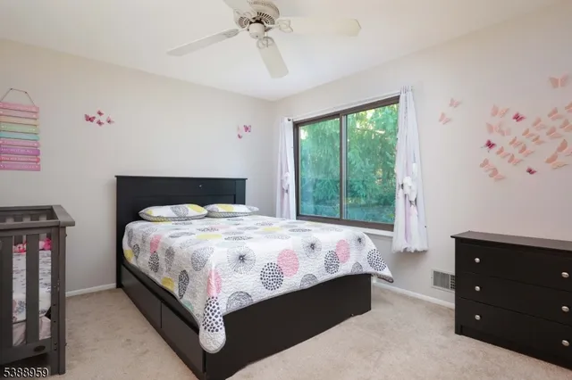 a bed sitting in a bedroom next to a window