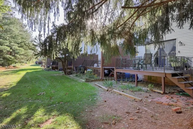 a view of a house with a yard table and chairs