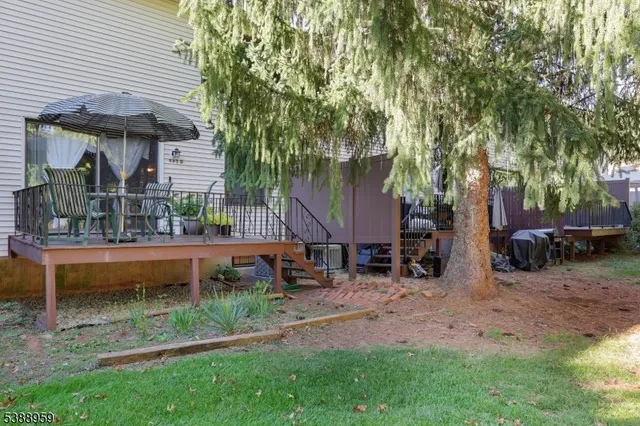 a backyard of a house with barbeque oven table and chairs