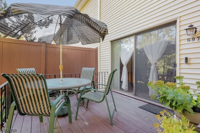 a view of a deck with furniture and wooden floor