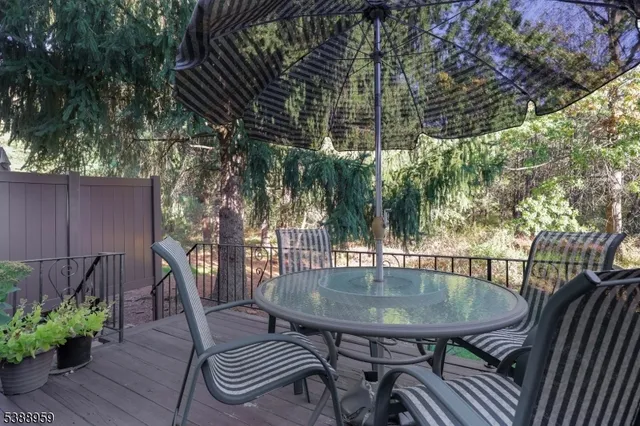 a view of balcony with table and chairs and potted plants