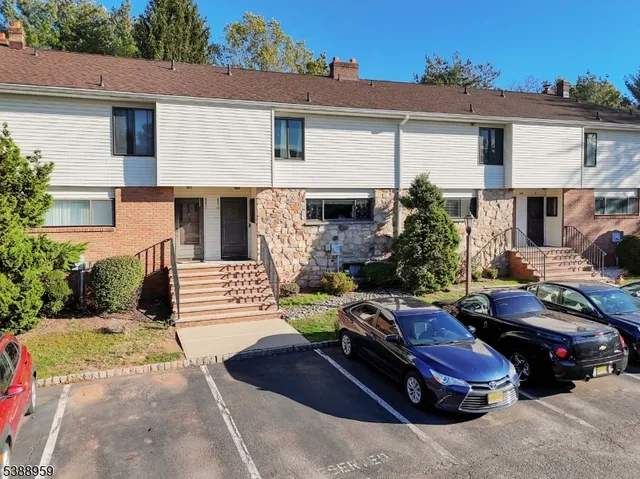 a view of a car park in front of house