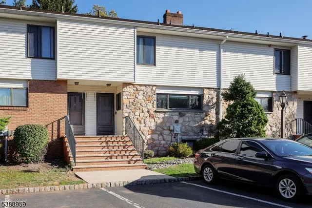 a view of a car parked front of a house