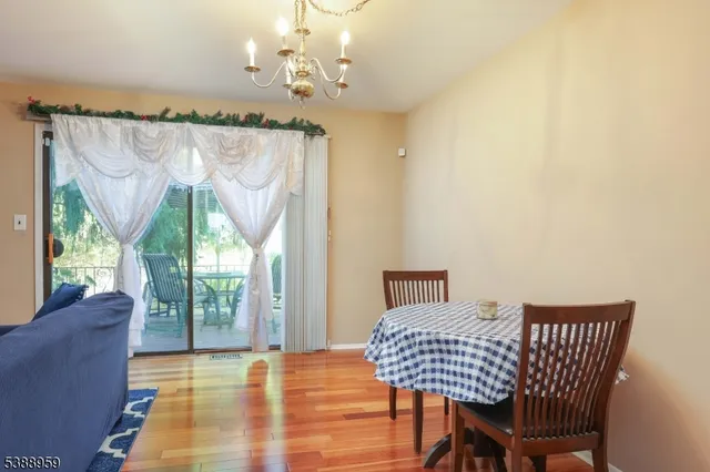 a view of a dining room with furniture wooden floor and chandelier
