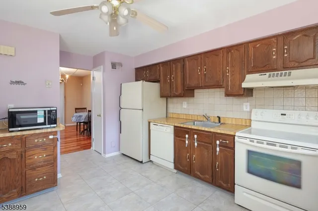 a kitchen with a refrigerator sink and stove