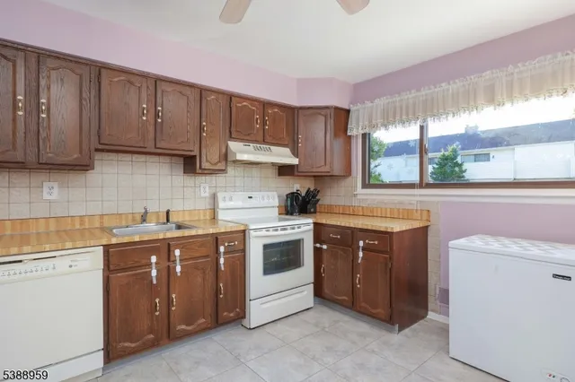 a kitchen with a stove sink and cabinets