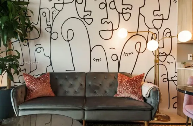 a living room with furniture and a potted plant