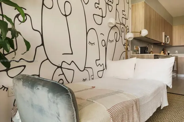 a picture of a room with a white bed and a stove