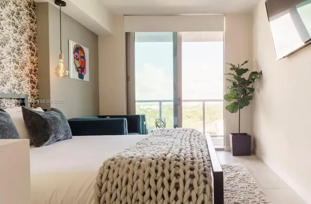 a bedroom with a bed and a large window