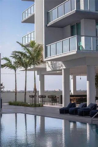 a front view of a house with lake view and a floor to ceiling window