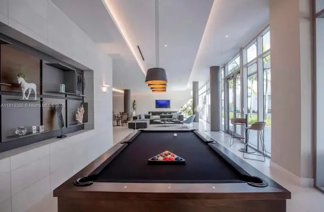 a room with pool table and a couch