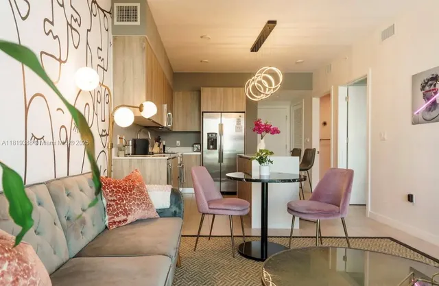 a view of a livingroom with furniture wooden floor and windows