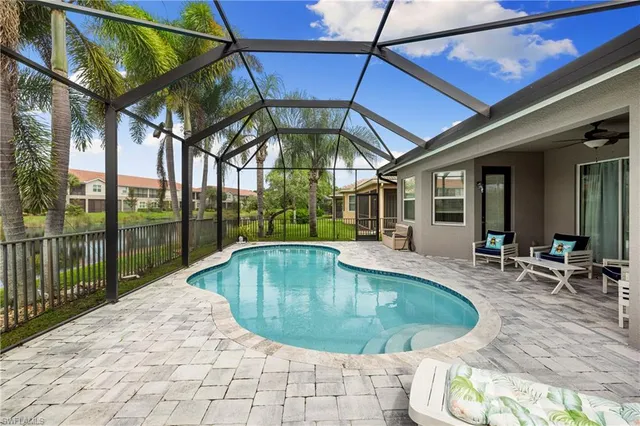 a swimming pool with outdoor seating and yard