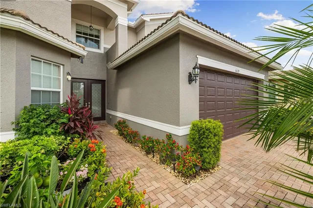 a backyard of a house with potted plants and flower plants