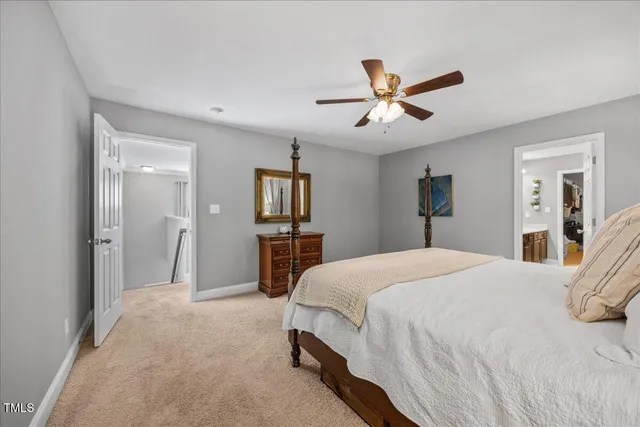 a spacious bedroom with a bed and a chandelier