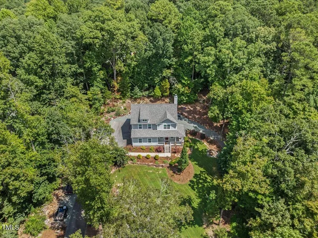 an aerial view of a house with a yard