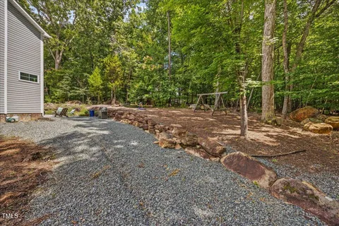 a view of a field with trees in the background