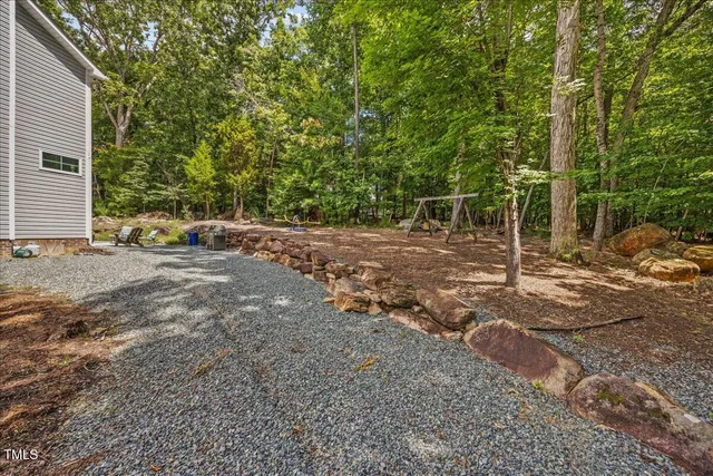 a view of a field with trees in the background