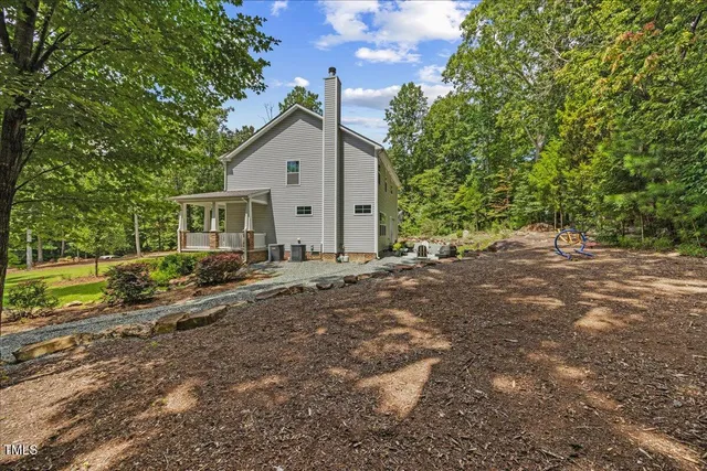 a view of backyard of house with green space