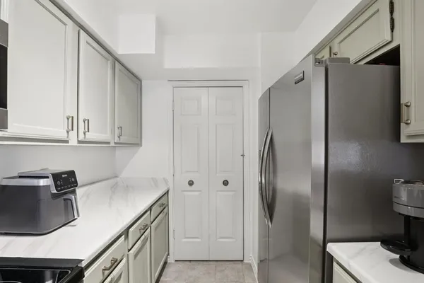 a kitchen with stainless steel appliances granite countertop a refrigerator and a sink