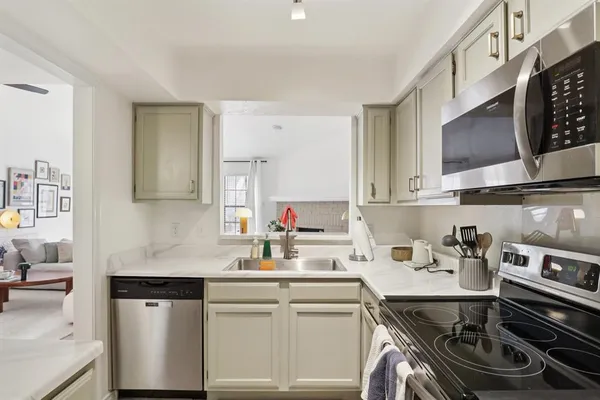a kitchen with a sink stove and cabinets