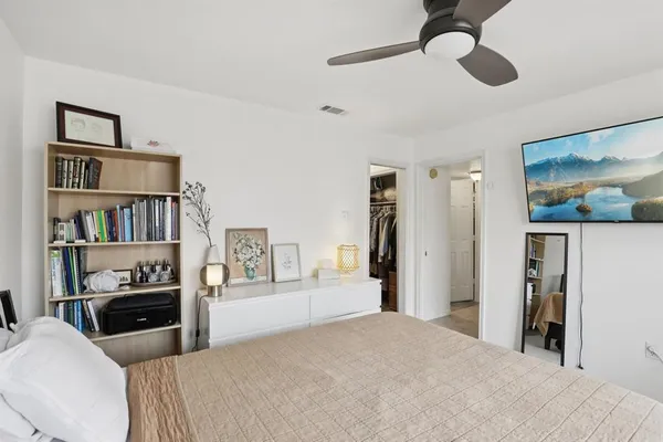 a bedroom with a bed cabinets and a book shelf